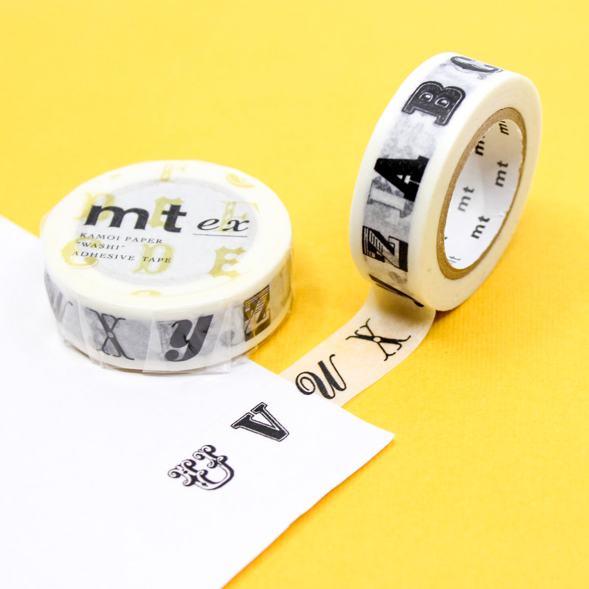 Add a touch of sophistication to your crafts with our gold and black classic typeface washi tape, featuring timeless typography in elegant gold and black hues, perfect for creating refined and stylish accents. This black typeface alphabet tape is from MT Brand Masking Tape and sold at BBB Supplies Craft Shop.