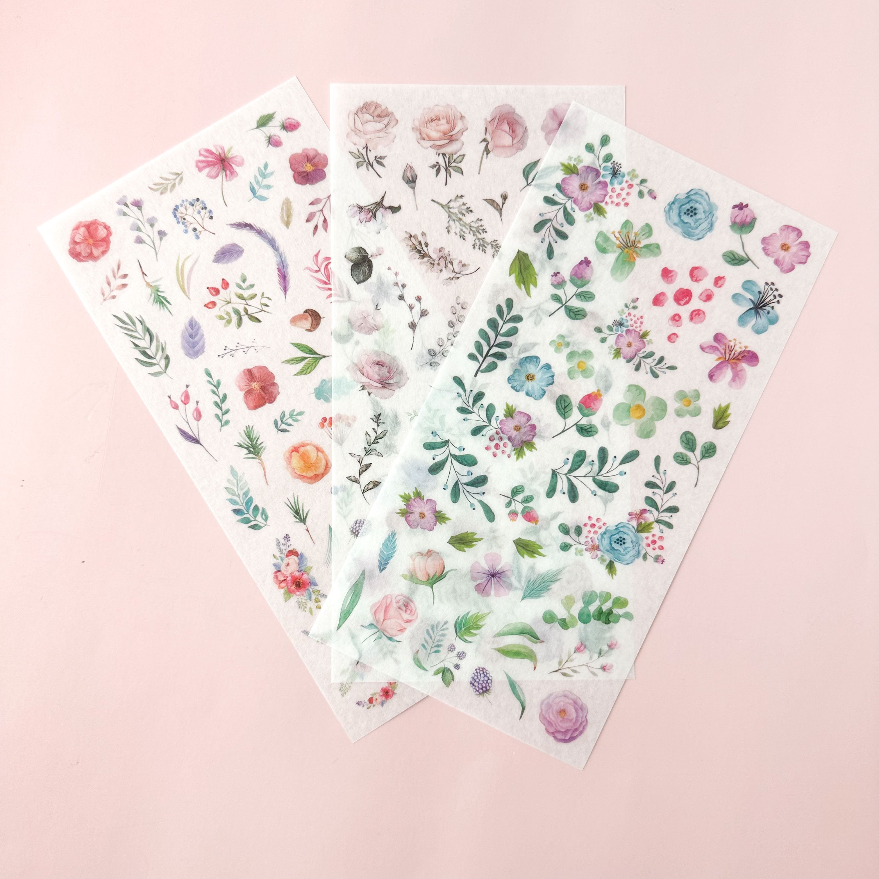 Three unique Flower Sticker sheets of floral stickers on a pink background