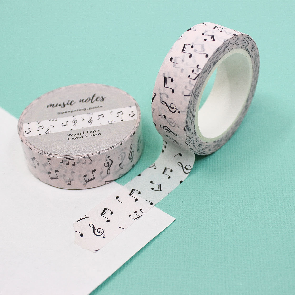 Tan and black music note washi tape featuring elegant black musical notes on a soft tan background, ideal for adding a refined touch to journals, planners, and crafts.