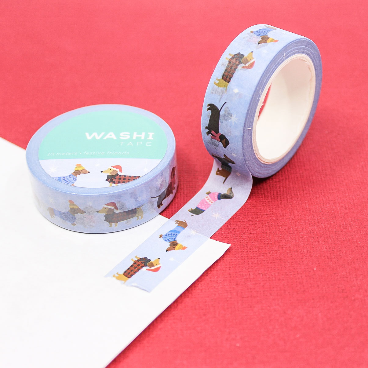 Cute winter washi tape featuring playful dogs in hats and scarves — ideal for Christmas paper crafts.