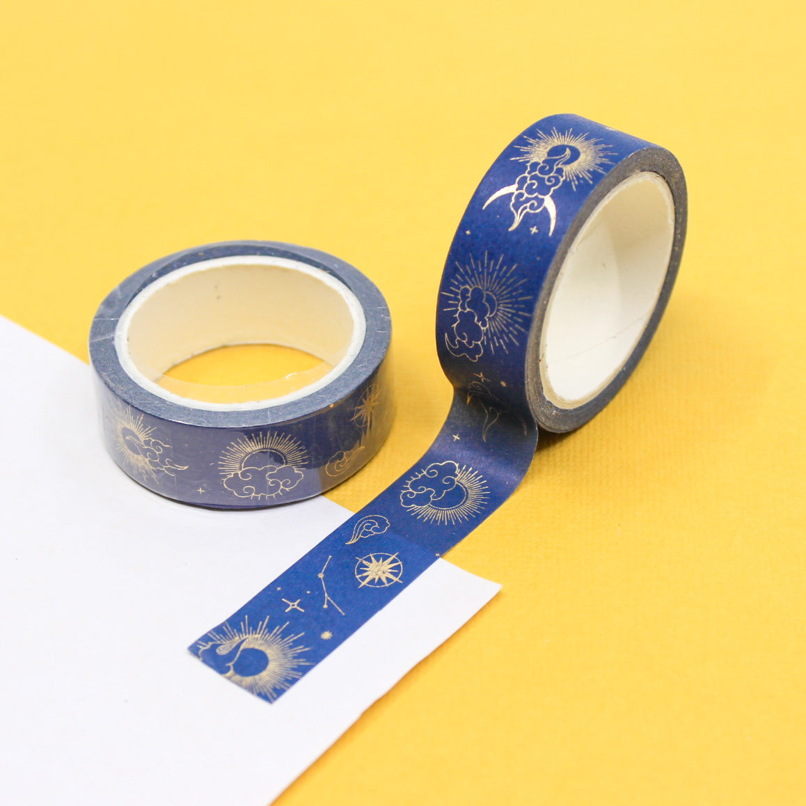 Gold foil sun, moon, and stars washi tape on blue background