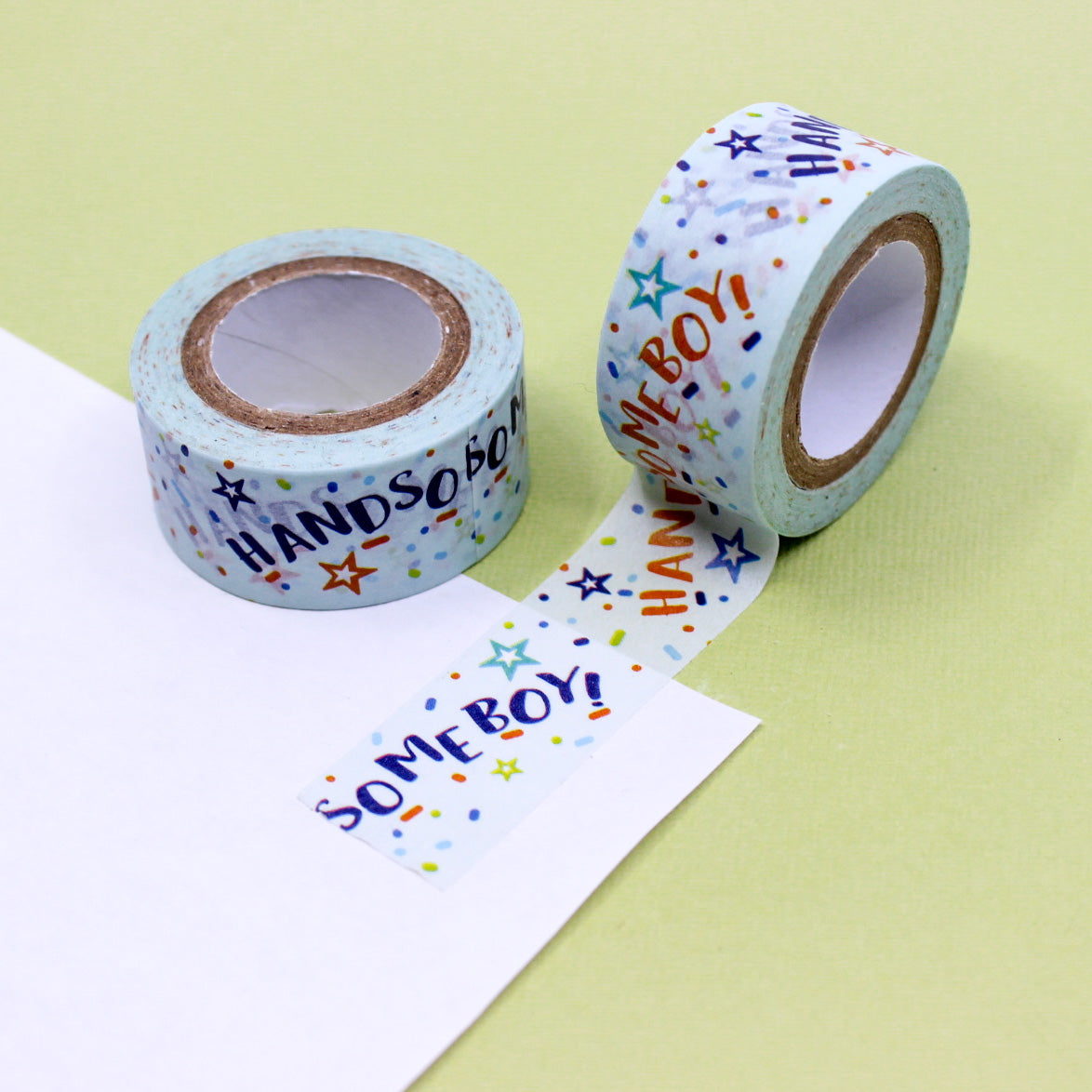 Blue washi tape roll with playful text 'Handsome Boy' and colorful confetti pattern.