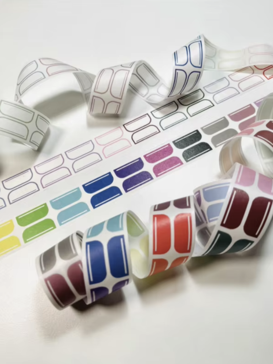 Rolls of two styles of self-adhesive divider tab washi tape rolls for planners and journals