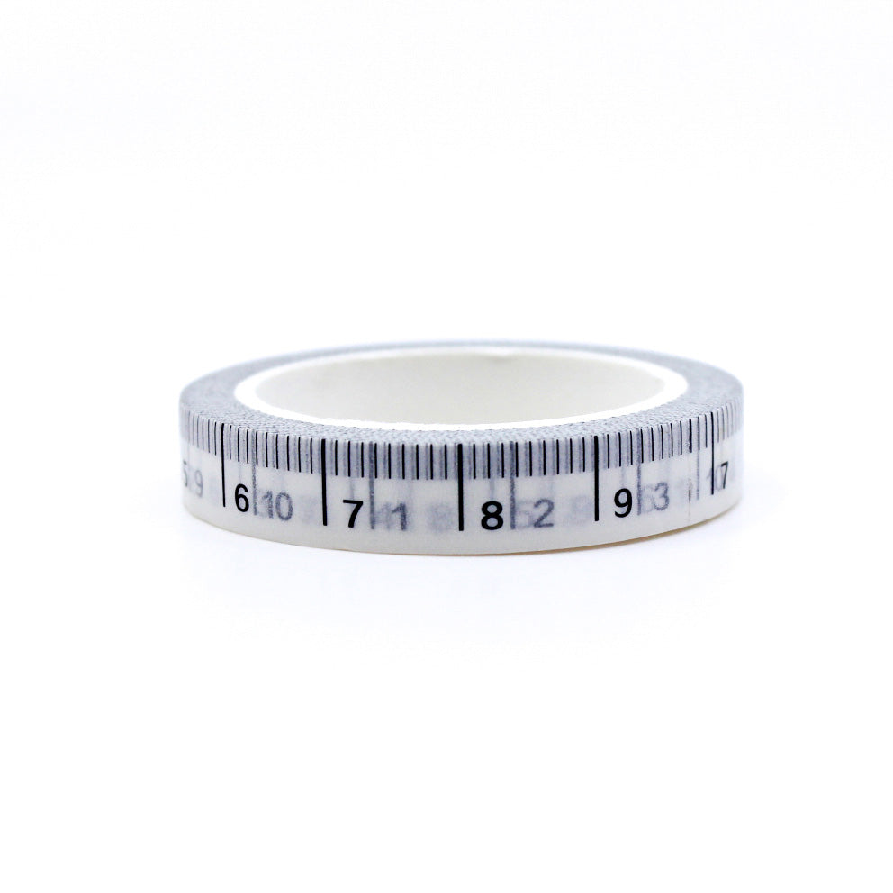 This washi tape features a design resembling a tape measure, perfect for adding a touch of creativity to your crafting or journaling projects. This tape is sold at BBB Supplies Craft Shop.