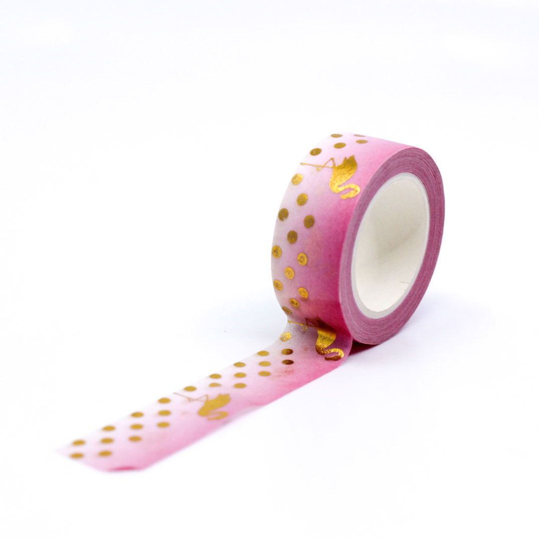 Roll of flamingo-themed washi tape featuring gold foil accents on soft pink.
