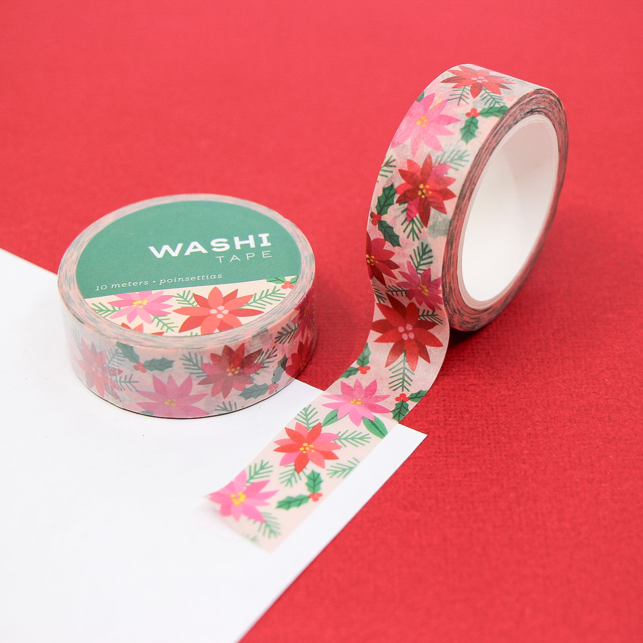 Cute Christmas washi tape roll featuring floral poinsettias and pine sprigs — holiday paper craft supply.