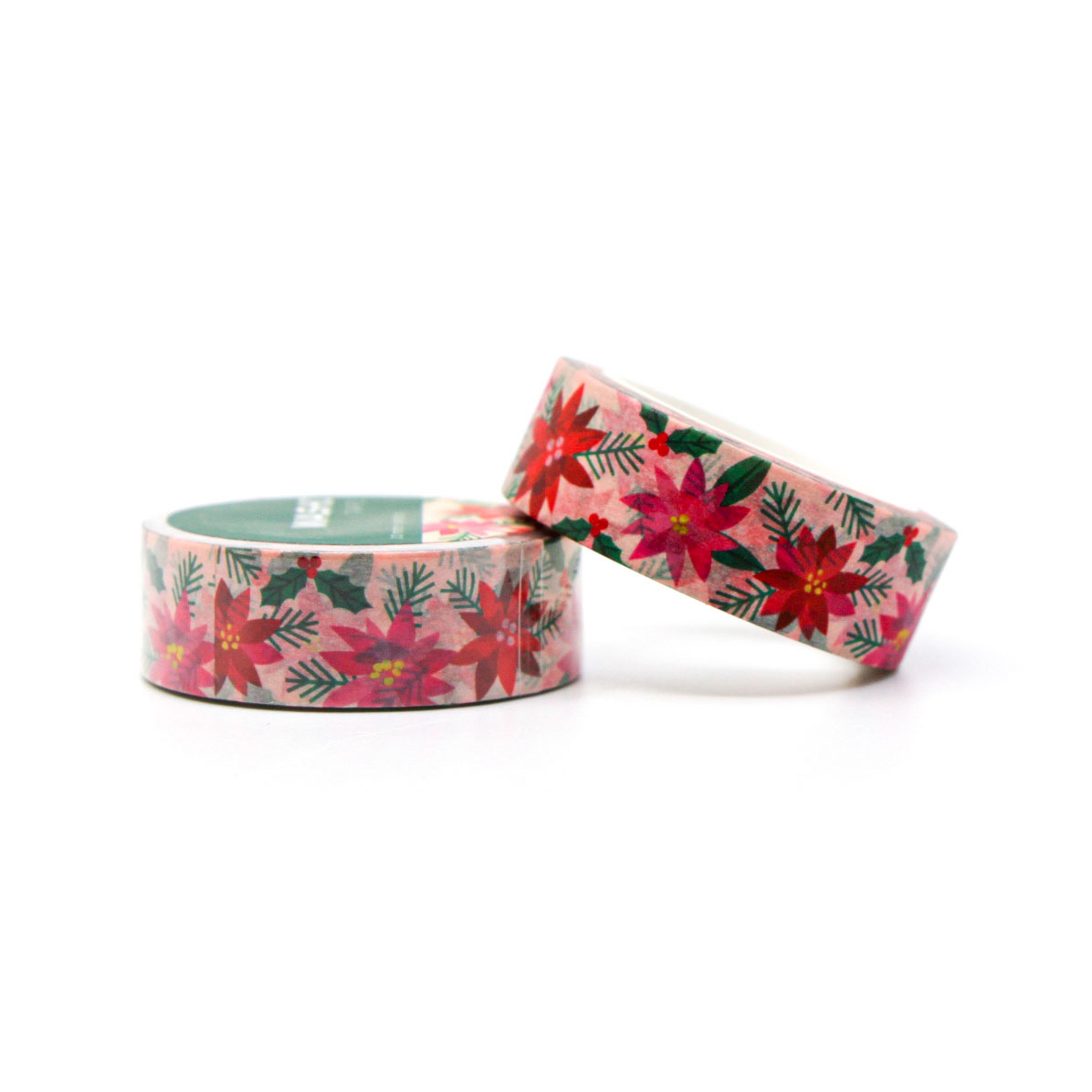 Christmas floral washi tape unrolled on pink background — decorative tape for holiday stationery.