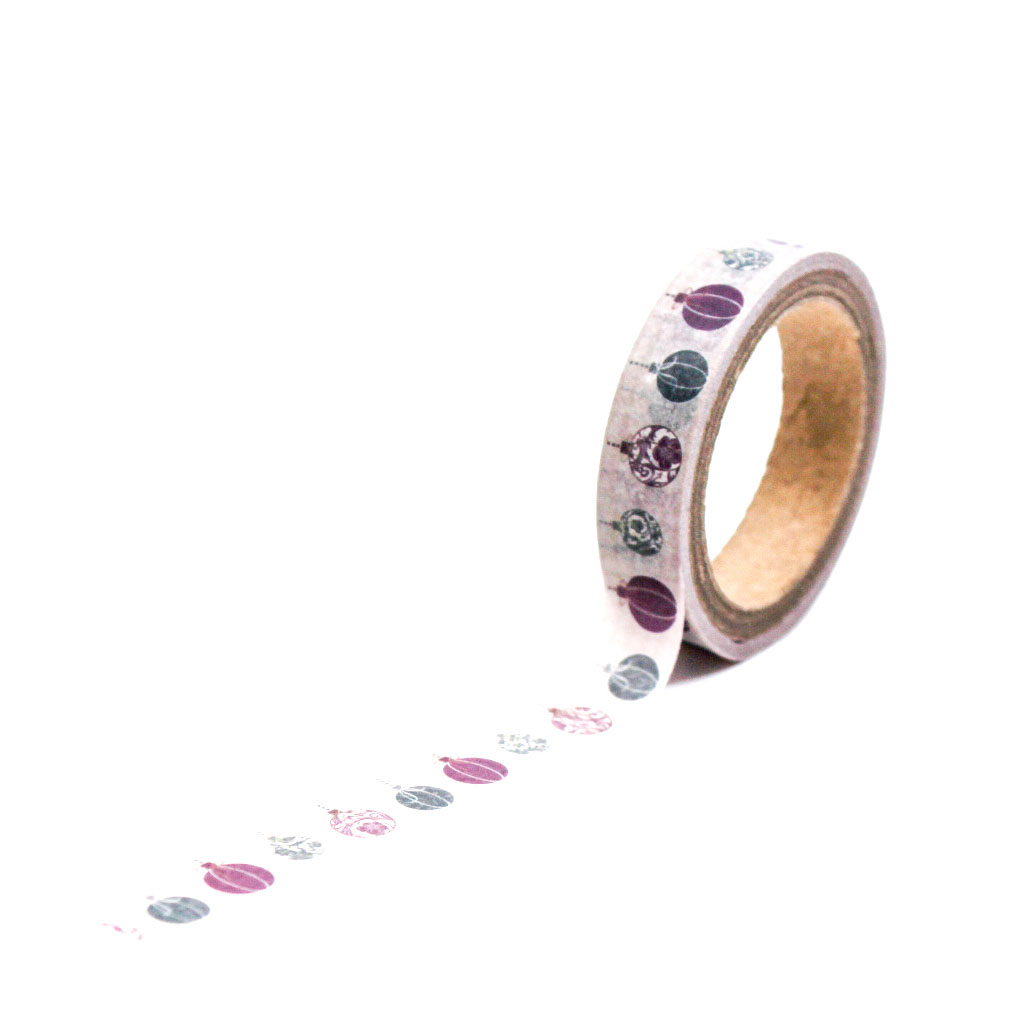 Close-up of holiday ornament washi tape roll styled for planners and scrapbooks.