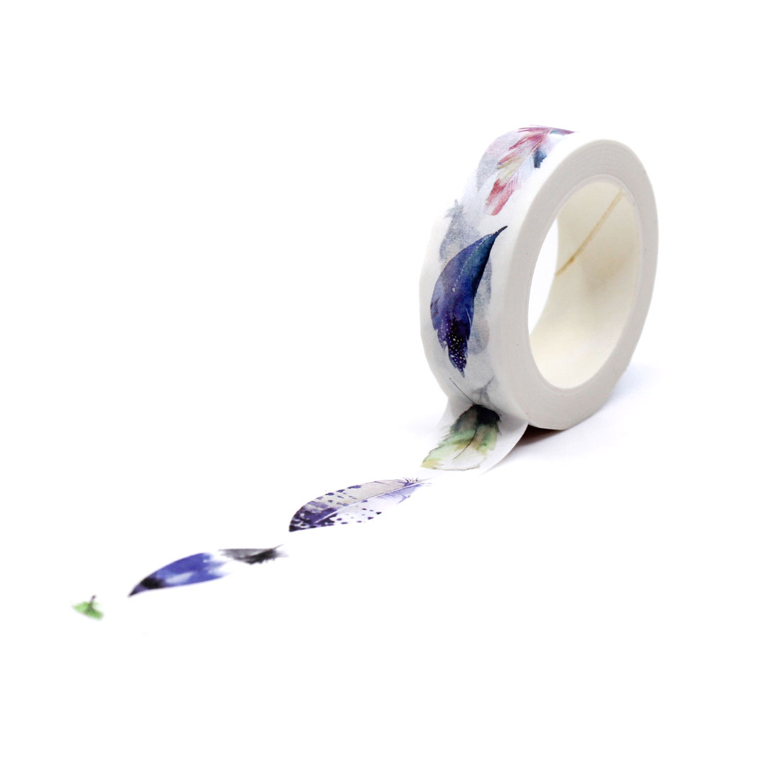 Decorative washi tape with soft watercolor feather pattern being unrolled onto paper.