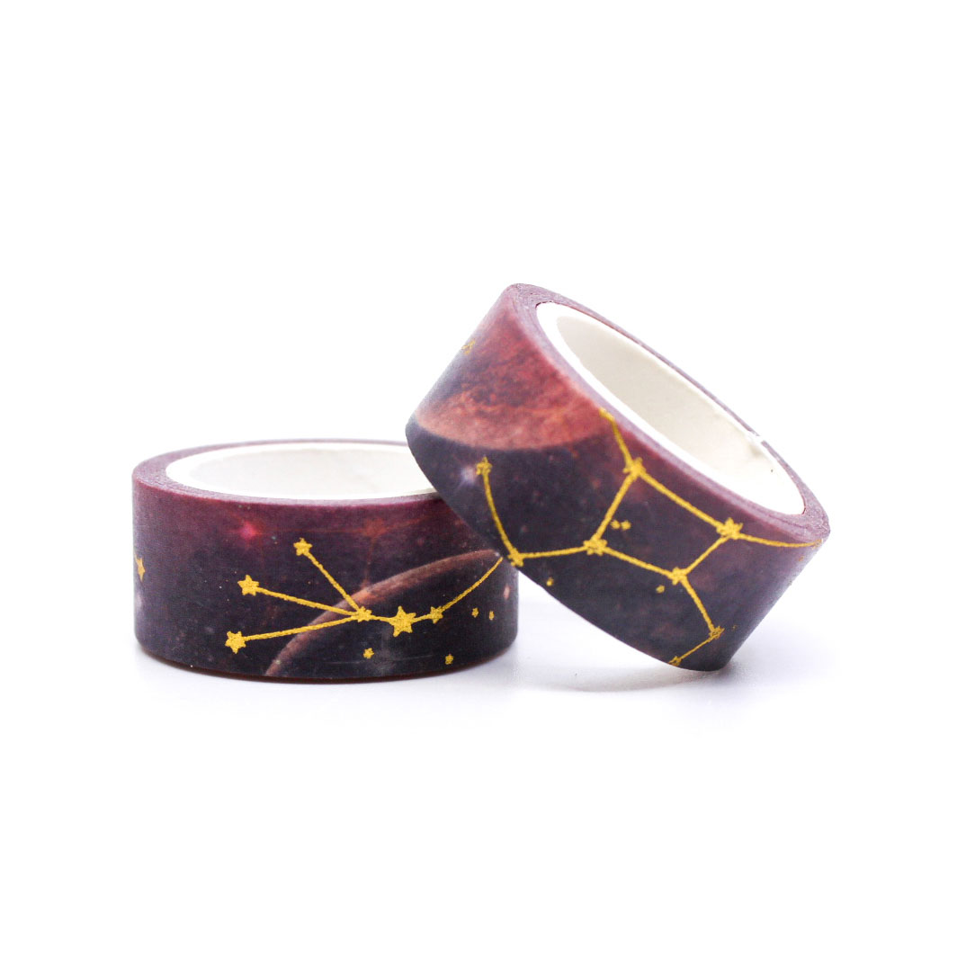Close-up of decorative galaxy washi tape with gold foil constellation design.