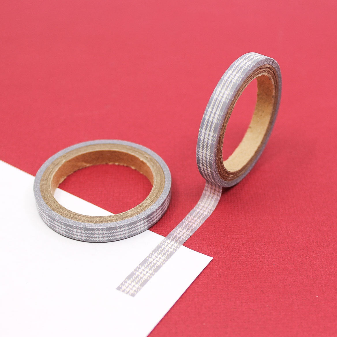 Close-up of minimalist grey and cream plaid tape roll for journaling and crafts.