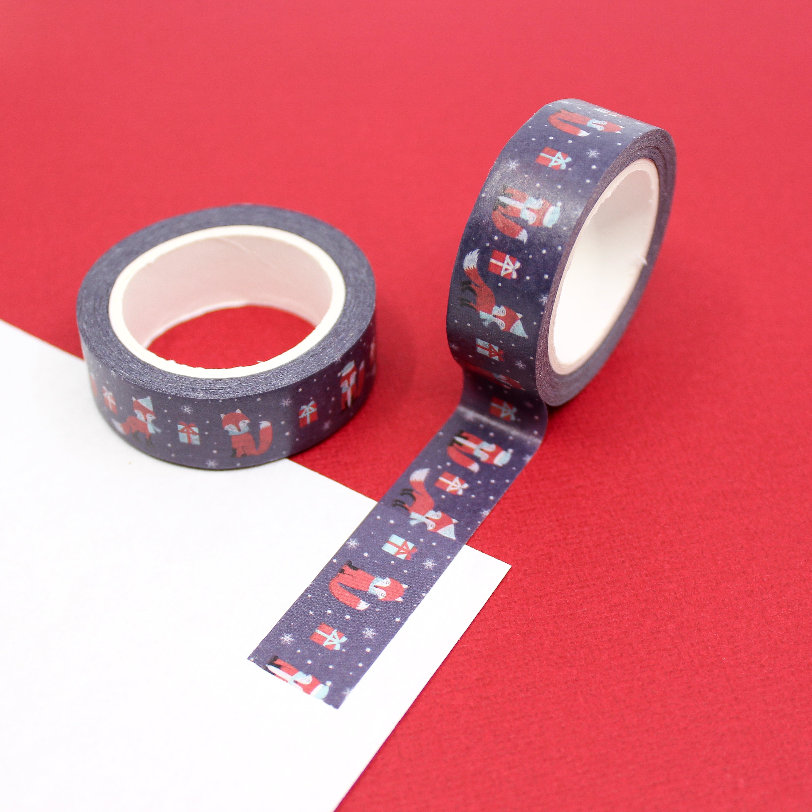 This is a photo of a navy blue and red fox washi tape. The fox is wearing a hat and scarf with a Christmas gift from BBB Supplies Journaling and Washi Craft Supply Shop.